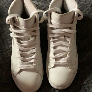 High top white Nike’s.
